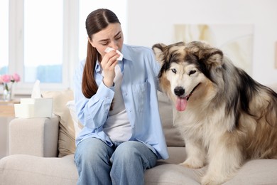 Photo of Woman suffering from allergy with her dog at home