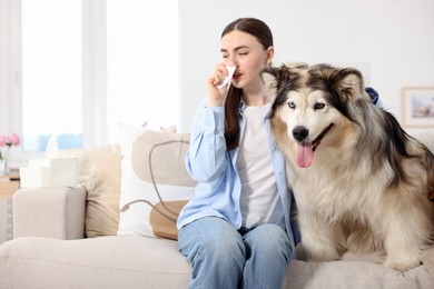 Photo of Woman suffering from allergy with her dog at home
