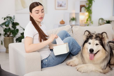 Photo of Woman suffering from allergy with her dog at home