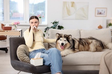 Photo of Woman suffering from allergy with her dog at home