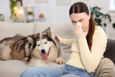 Photo of Woman suffering from allergy with her dog at home