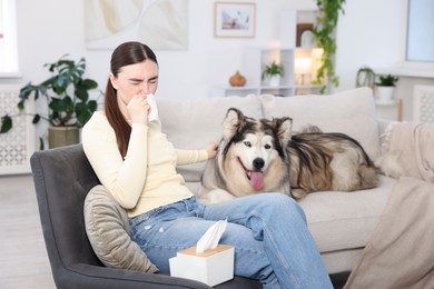 Photo of Woman suffering from allergy with her dog at home