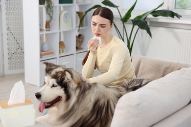 Photo of Woman suffering from allergy with her dog at home