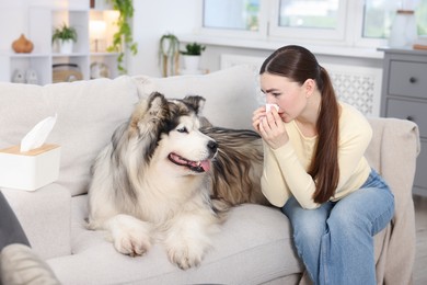 Photo of Woman suffering from allergy with her dog at home