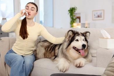 Photo of Woman suffering from allergy with her dog at home