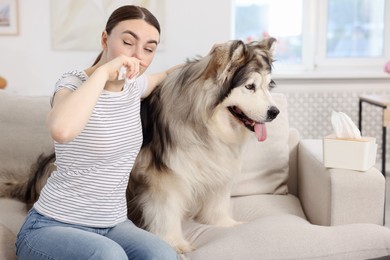 Photo of Woman suffering from allergy with her dog at home