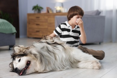 Photo of Boy suffering from allergy with her dog at home