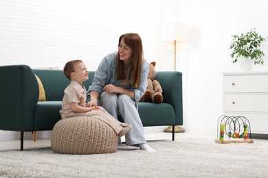 Photo of Happy mother spending time together with her son at home