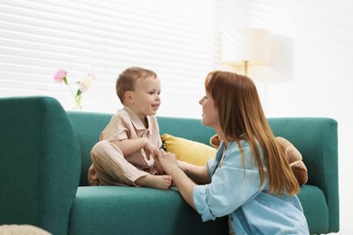 Photo of Happy mother spending time together with her son at home