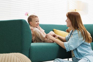Photo of Happy mother spending time together with her son at home