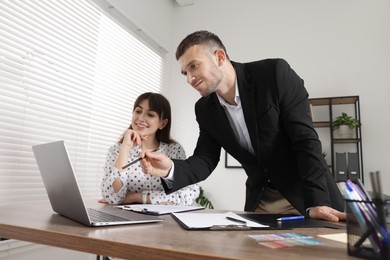Photo of Consultant working with client at table in office, low angle view. Business meeting