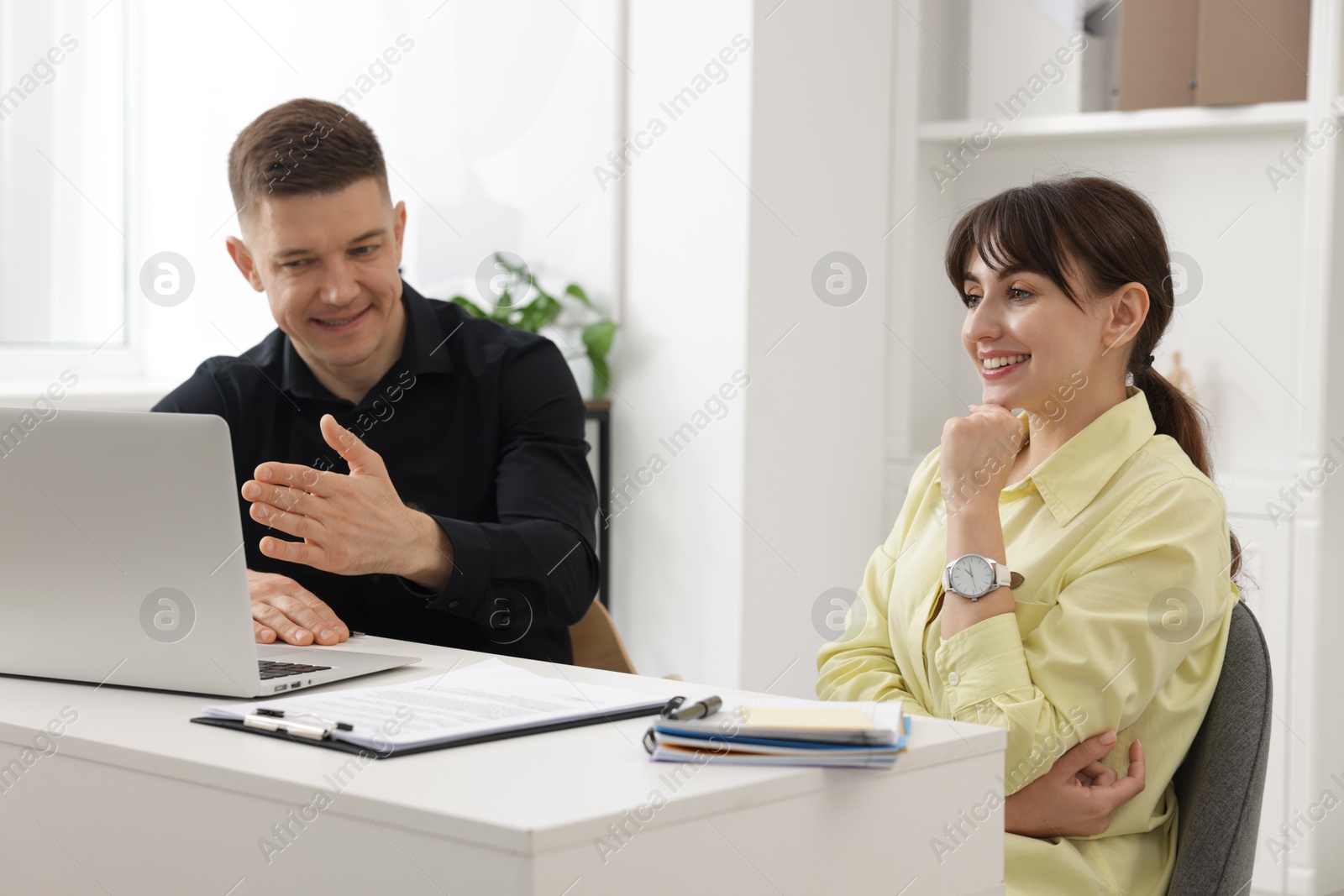 Consultant working with client at table in office. Business meeting Photo of Consultant working with client at table in office. Business meeting