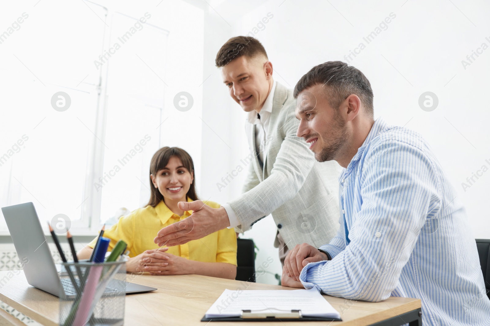 Couple having meeting with business consultant at table in office Photo of Couple having meeting with business consultant at table in office