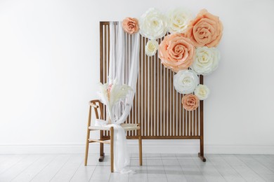 Photo of Photo zone with beautiful floral decor in studio