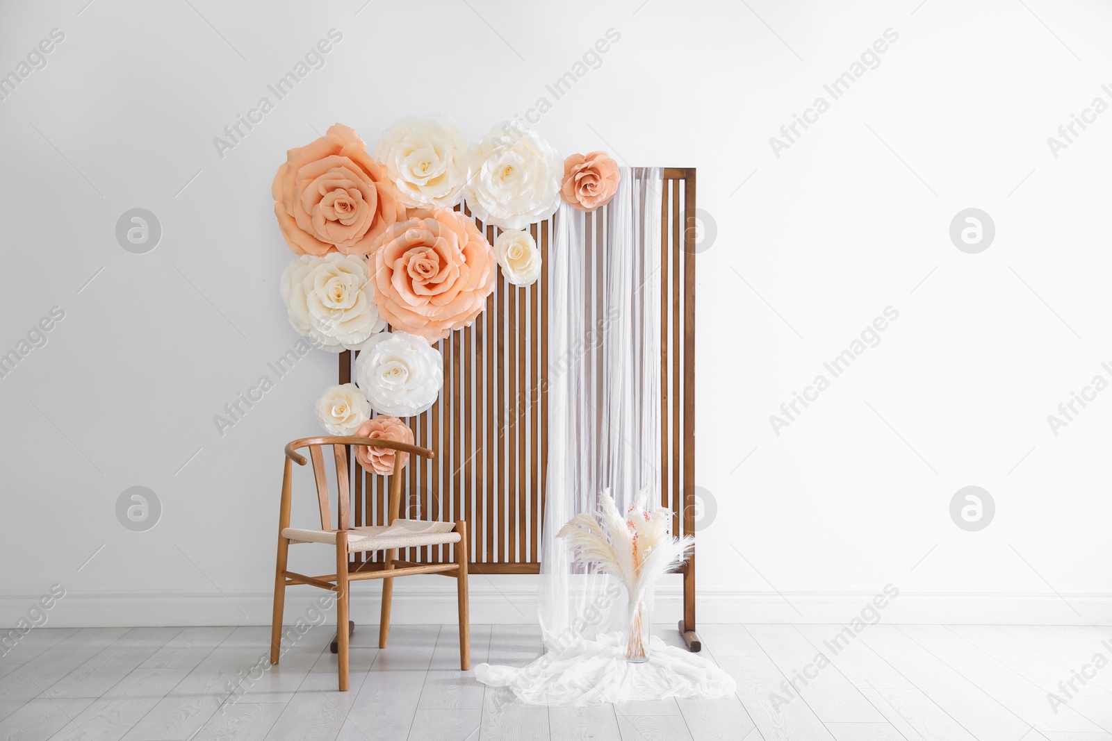 Photo zone with beautiful floral decor in studio Photo of Photo zone with beautiful floral decor in studio