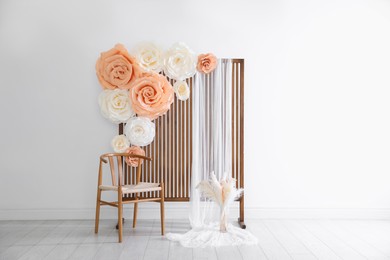 Photo of Photo zone with beautiful floral decor in studio