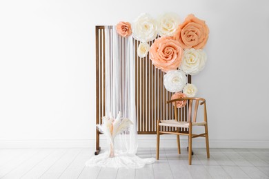 Photo of Photo zone with beautiful floral decor in studio