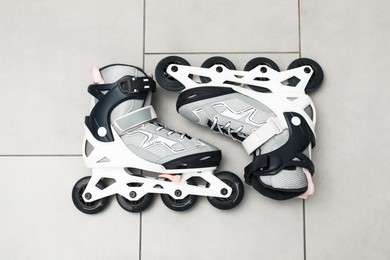Photo of Pair of roller skates on floor, top view