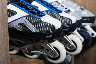 Photo of Pairs of roller skates in shelving unit, closeup