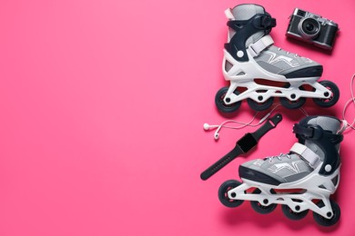 Photo of Flat lay composition with roller skates on pink background. Space for text