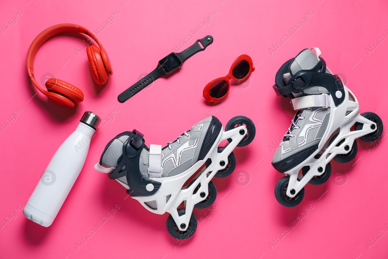 Flat lay composition with roller skates on pink background Photo of Flat lay composition with roller skates on pink background