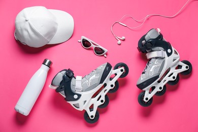 Photo of Flat lay composition with roller skates on pink background