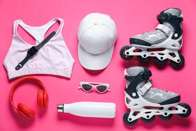 Photo of Flat lay composition with roller skates on pink background