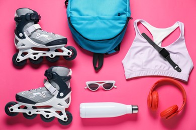 Photo of Flat lay composition with roller skates on pink background