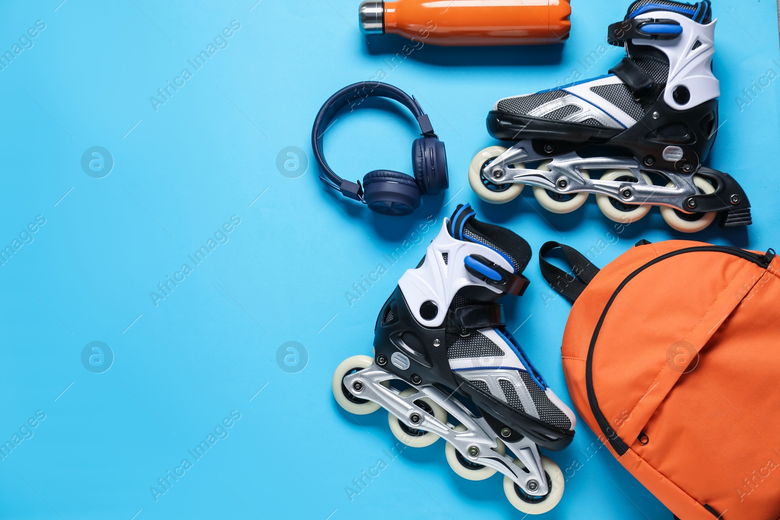 Flat lay composition with roller skates on blue background. Space for text Photo of Flat lay composition with roller skates on blue background. Space for text