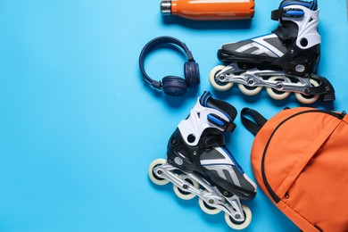 Photo of Flat lay composition with roller skates on blue background. Space for text