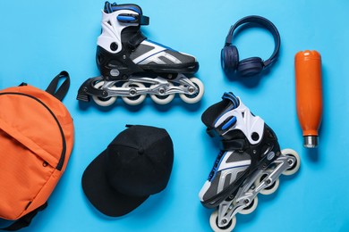 Photo of Flat lay composition with roller skates on blue background