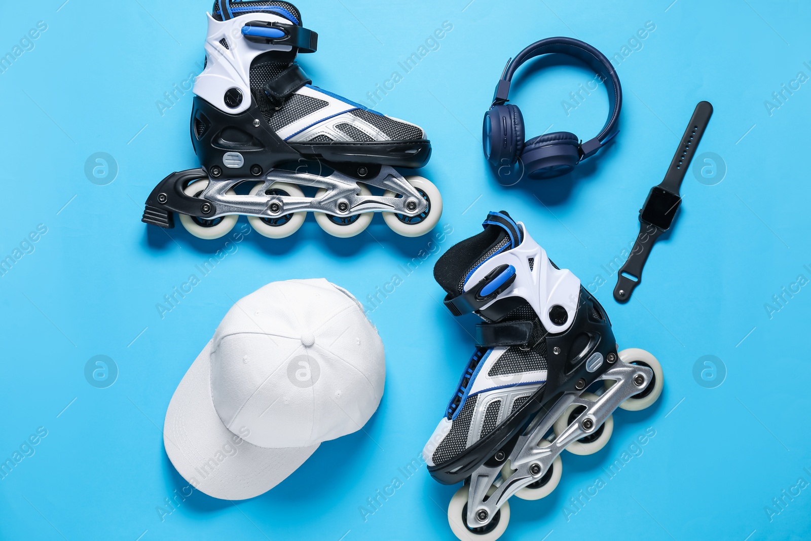 Flat lay composition with roller skates on blue background Photo of Flat lay composition with roller skates on blue background