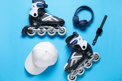 Photo of Flat lay composition with roller skates on blue background