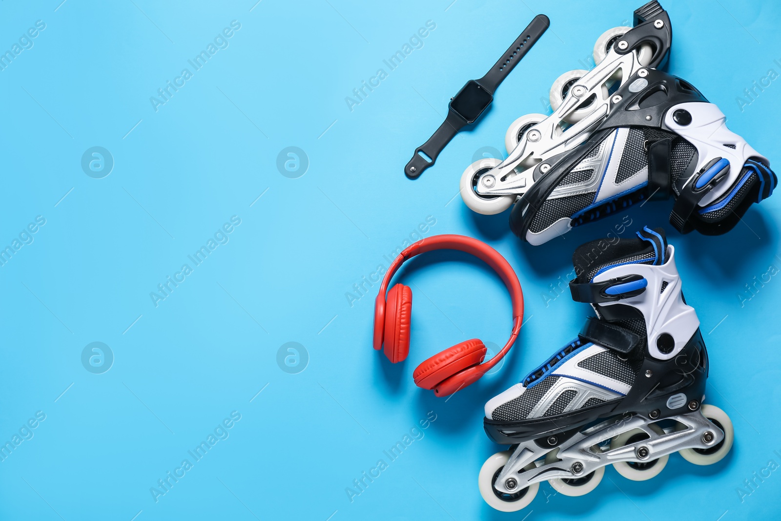 Flat lay composition with roller skates on blue background. Space for text Photo of Flat lay composition with roller skates on blue background. Space for text