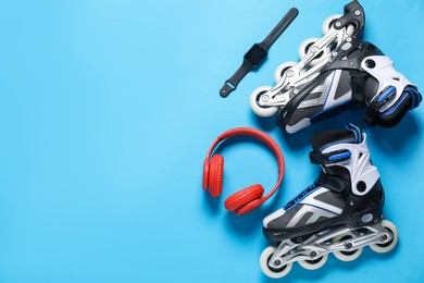Photo of Flat lay composition with roller skates on blue background. Space for text