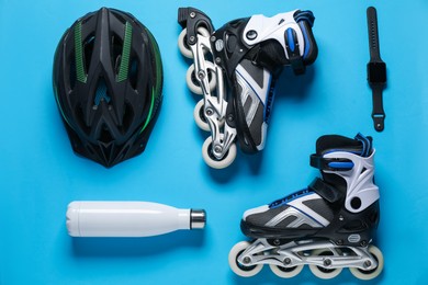 Photo of Flat lay composition with roller skates on blue background