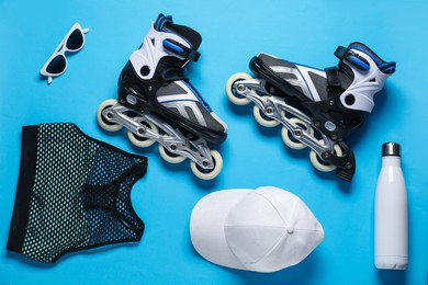 Photo of Flat lay composition with roller skates on blue background