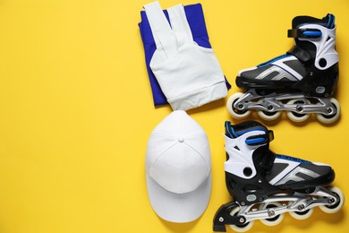 Photo of Flat lay composition with roller skates on yellow background. Space for text
