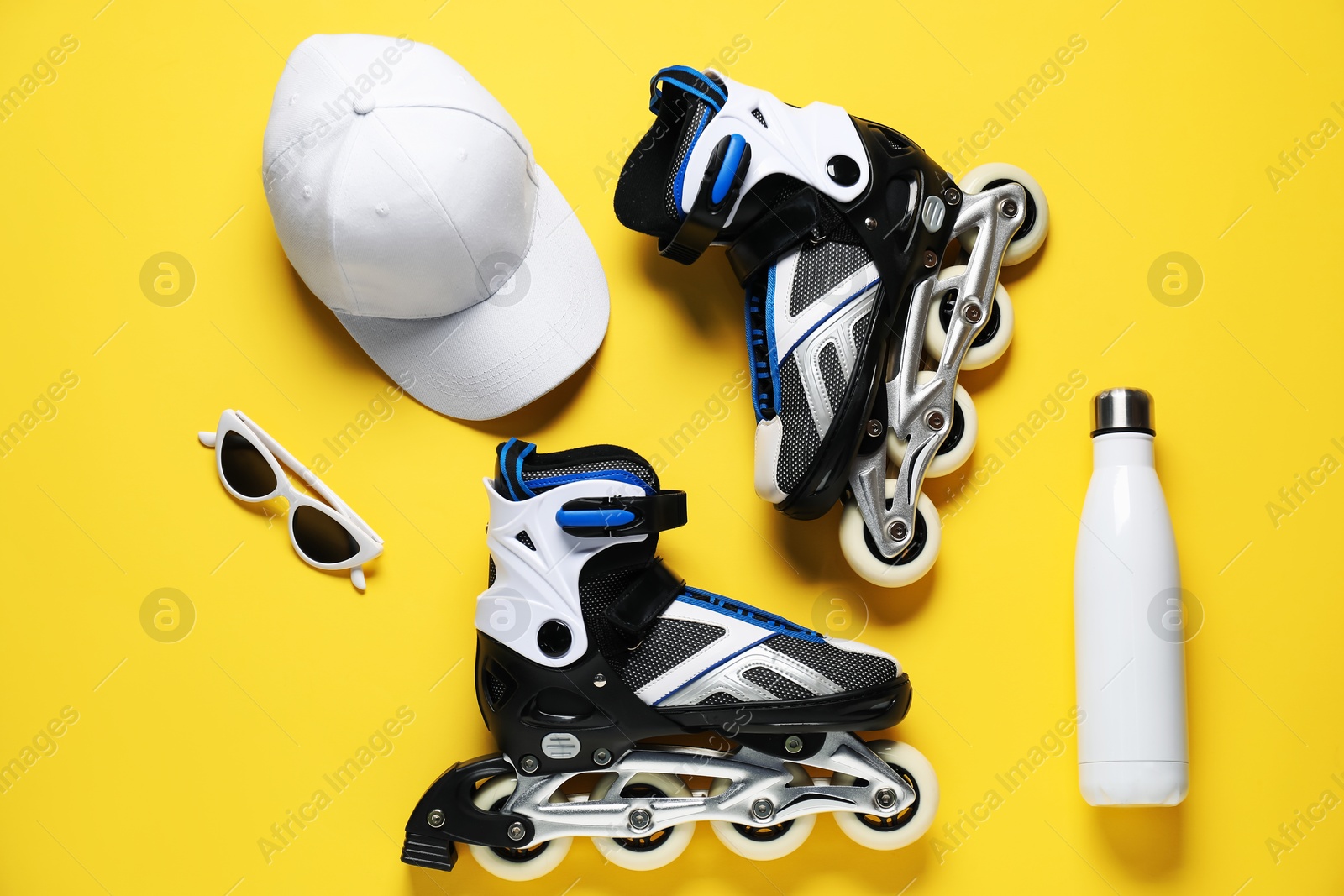 Flat lay composition with roller skates on yellow background Photo of Flat lay composition with roller skates on yellow background