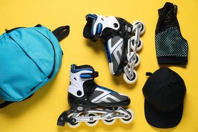 Photo of Flat lay composition with roller skates on yellow background