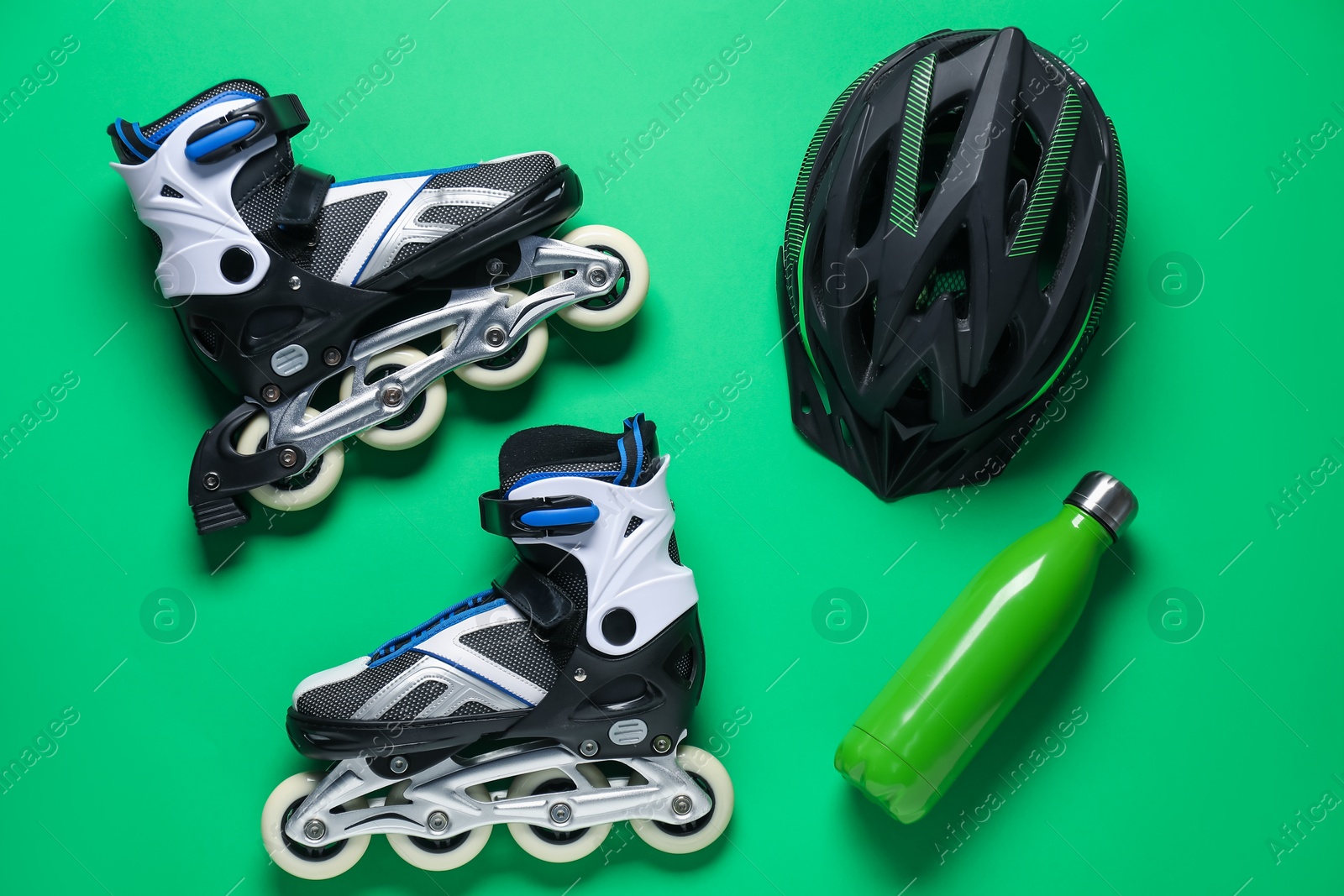 Flat lay composition with roller skates on green background Photo of Flat lay composition with roller skates on green background