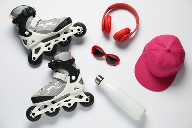 Photo of Flat lay composition with roller skates on white background