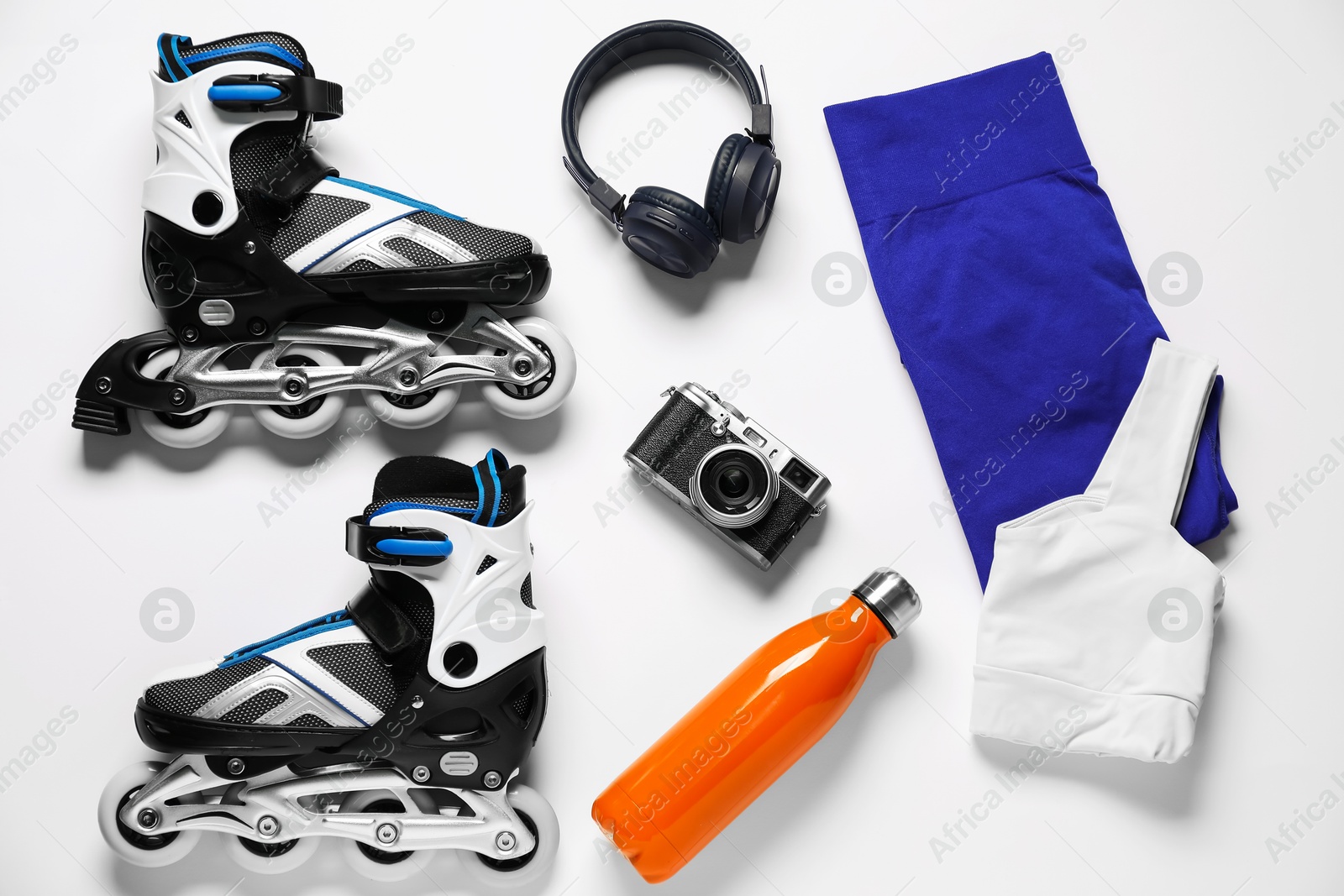 Flat lay composition with roller skates on white background Photo of Flat lay composition with roller skates on white background