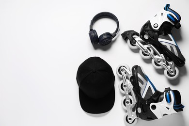 Photo of Flat lay composition with roller skates on white background. Space for text
