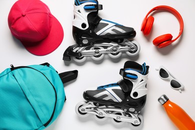 Photo of Flat lay composition with roller skates on white background