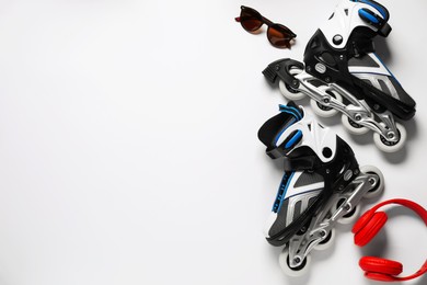Photo of Flat lay composition with roller skates on white background. Space for text