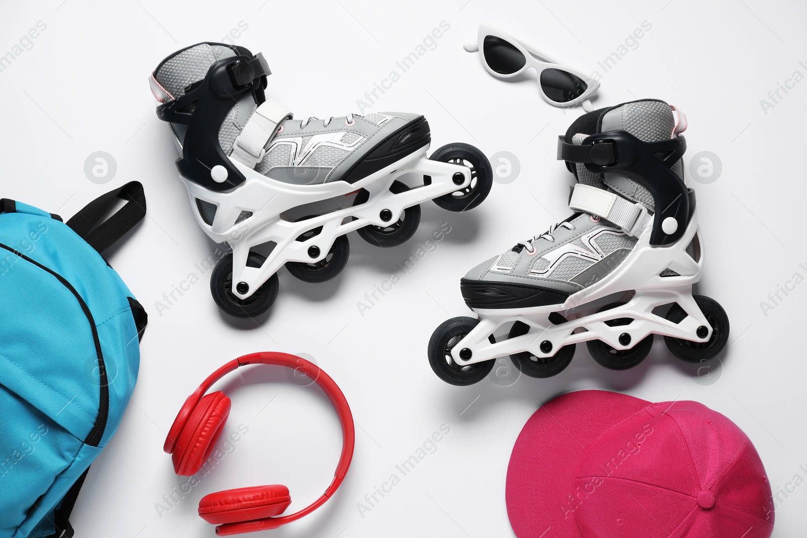 Flat lay composition with roller skates on white background Photo of Flat lay composition with roller skates on white background