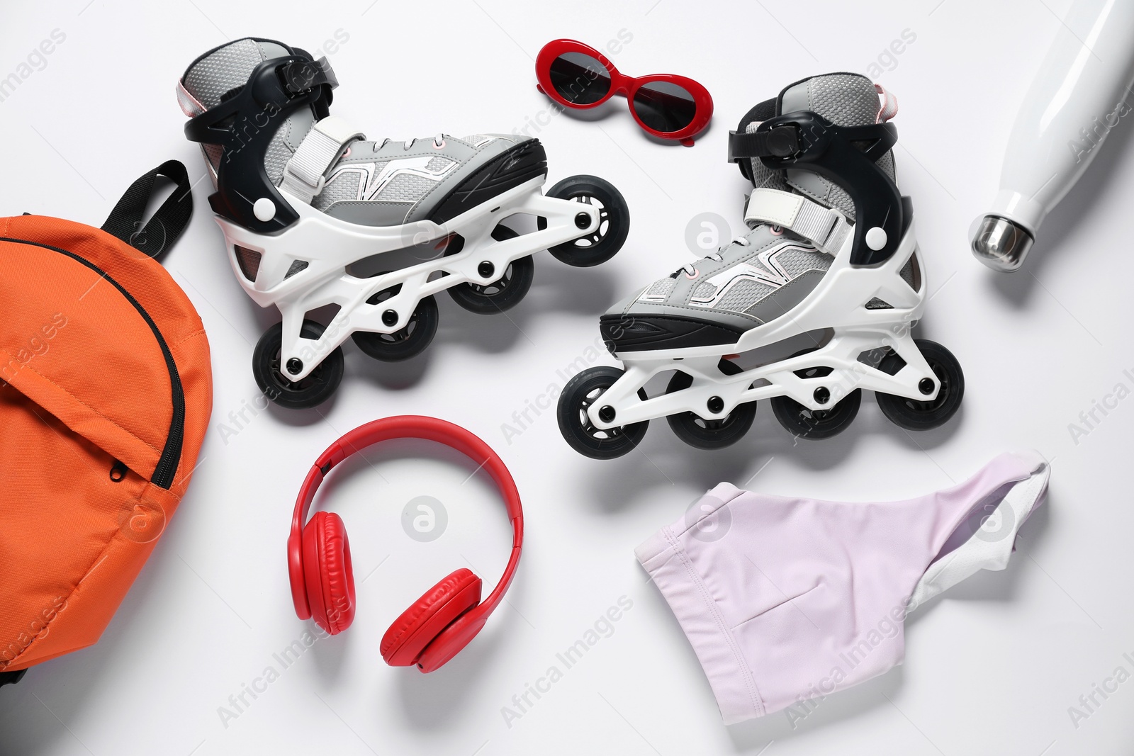 Flat lay composition with roller skates on white background Photo of Flat lay composition with roller skates on white background