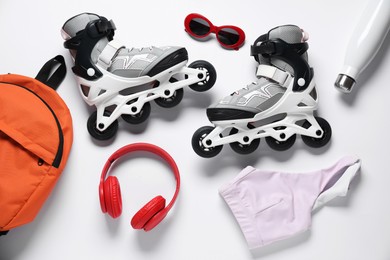 Photo of Flat lay composition with roller skates on white background