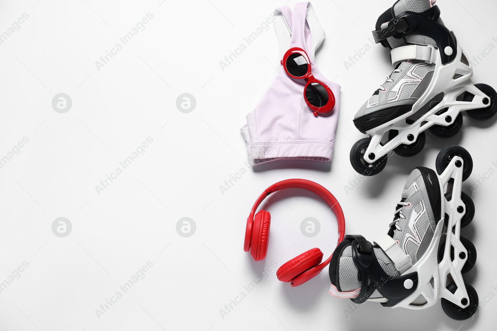 Flat lay composition with roller skates on white background. Space for text Photo of Flat lay composition with roller skates on white background. Space for text